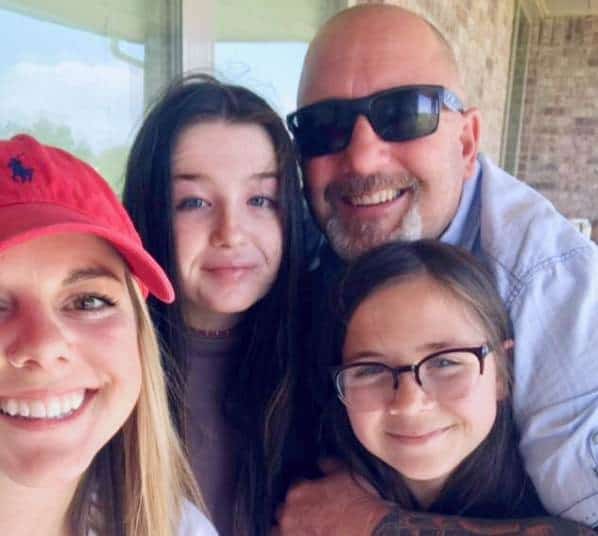 Image of an American drag racer, Chuck Seitsinger with his daughters
